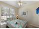 Bright bedroom features a ceiling fan, TV, and a cheerful floral bedspread on a white frame at 2322 Silver Palm Dr, Kissimmee, FL 34747