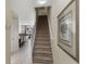Inviting entryway featuring a staircase, neutral tones, and tile flooring, leading to the living area at 2322 Silver Palm Dr, Kissimmee, FL 34747