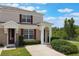 Well-kept townhome with neat front yard featuring lush greenery and an inviting entryway at 2322 Silver Palm Dr, Kissimmee, FL 34747