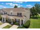 Beautiful townhome exterior features a well-kept lawn and manicured landscaping at 2322 Silver Palm Dr, Kissimmee, FL 34747