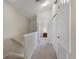 Hallway on the second floor with doors, stairs, storage, and view to a bedroom at the end at 2322 Silver Palm Dr, Kissimmee, FL 34747