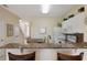 Bright kitchen with granite countertops, white cabinetry, and adjacent dining area with seating at 2322 Silver Palm Dr, Kissimmee, FL 34747