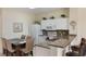 Bright kitchen with granite countertops, white cabinetry, and adjacent dining area with seating at 2322 Silver Palm Dr, Kissimmee, FL 34747