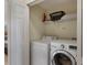 Convenient laundry room features a washer, dryer, and overhead storage shelf at 2322 Silver Palm Dr, Kissimmee, FL 34747