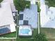Aerial view of the home highlighting the backyard pool, green lawn, and solar panels at 2341 Stone Cross Cir, Orlando, FL 32828
