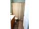 Cozy bathroom featuring a neutral shower curtain and dark tile flooring at 2341 Stone Cross Cir, Orlando, FL 32828