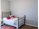 Bedroom with a decorative throw rug, iron bed frame and neutral wall paint at 2341 Stone Cross Cir, Orlando, FL 32828