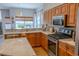 Well-appointed kitchen with stainless steel appliances, marble countertops, and ample cabinet space at 2341 Stone Cross Cir, Orlando, FL 32828