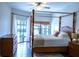 Spacious main bedroom featuring a four-poster bed and sliding glass doors to the pool at 2341 Stone Cross Cir, Orlando, FL 32828