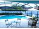 A lovely screened pool area with outdoor seating and lounge chairs at 2341 Stone Cross Cir, Orlando, FL 32828