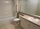 Bathroom with bathtub, shower, and vanity with cabinet at 239 Longview Ave # 107, Celebration, FL 34747