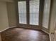 Bright bedroom featuring wood-look floors and natural light streaming through large windows at 239 Longview Ave # 107, Celebration, FL 34747