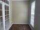A bright and airy bonus room features natural light from the windows and french doors, and wood-look flooring at 239 Longview Ave # 107, Celebration, FL 34747