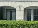 Close up on exterior trim and windows above a manicured green shrub, showcasing architectural details at 239 Longview Ave # 107, Celebration, FL 34747