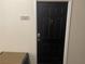 Contemporary black front door featuring a sleek design, modern hardware, and a clearly marked address number at 239 Longview Ave # 107, Celebration, FL 34747