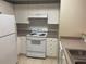 Well-maintained kitchen features white appliances and ample cabinet space at 239 Longview Ave # 107, Celebration, FL 34747