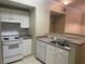 Well-maintained kitchen features white appliances and ample counter space at 239 Longview Ave # 107, Celebration, FL 34747