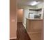 Bright view looking towards kitchen featuring white cabinets, eat-in bar, and a connecting hallway at 239 Longview Ave # 107, Celebration, FL 34747