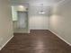 Open living room with hardwood floors and a chandelier at 239 Longview Ave # 107, Celebration, FL 34747