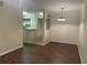 An open concept living room, showcasing dark wood floors, crown molding, and easy access to the kitchen at 239 Longview Ave # 107, Celebration, FL 34747