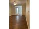 Bright living room featuring hardwood floors, ceiling fan, and French doors at 239 Longview Ave # 107, Celebration, FL 34747
