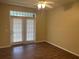 Bright living room featuring hardwood floors, ceiling fan, and French doors at 239 Longview Ave # 107, Celebration, FL 34747