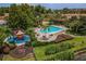 Aerial view of the pool area and playground and lush landscaping of this vibrant community at 3015 Yellow Lantana Ln, Kissimmee, FL 34747