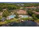 Aerial view featuring the pools, clubhouse, dock and surrounding landscaping of this vibrant community at 3015 Yellow Lantana Ln, Kissimmee, FL 34747