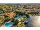 An aerial view features the pools, clubhouse, dock, and multiple buildings of this vibrant community at 3015 Yellow Lantana Ln, Kissimmee, FL 34747
