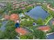Beautiful community aerial view featuring a large lake, swimming pool, clubhouse, and well-maintained landscaping at 3015 Yellow Lantana Ln, Kissimmee, FL 34747