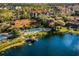 Breathtaking aerial perspective of a community with a lake, clubhouse, pool, and lush greenery at 3015 Yellow Lantana Ln, Kissimmee, FL 34747