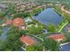 Aerial view of the resort community, with a lake, pools, playgrounds, and tile-roofed buildings at 3015 Yellow Lantana Ln, Kissimmee, FL 34747