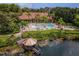 An aerial view showcases the pool, clubhouse, dock, and lake access within a lush community at 3015 Yellow Lantana Ln, Kissimmee, FL 34747