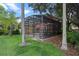 Enclosed backyard pool area and patio offers a private oasis surrounded by lush landscaping at 3015 Yellow Lantana Ln, Kissimmee, FL 34747