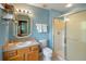 Bright bathroom with a glass-enclosed shower, vanity, and blue walls at 3015 Yellow Lantana Ln, Kissimmee, FL 34747