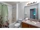 Bright bathroom featuring a shower and tub combination with tile surround and neutral-toned vanity at 3015 Yellow Lantana Ln, Kissimmee, FL 34747