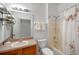 Neutral bathroom offers a shower and tub combination, ample counter space, and open shelving at 3015 Yellow Lantana Ln, Kissimmee, FL 34747