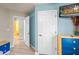 Stylish bedroom showcasing a closet door and white door, bright blue walls, and comfortable furnishings at 3015 Yellow Lantana Ln, Kissimmee, FL 34747