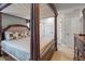 Spacious bedroom with a stunning canopy bed, complemented by ample closet space and neutral decor at 3015 Yellow Lantana Ln, Kissimmee, FL 34747
