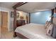 Inviting bedroom featuring a luxurious canopy bed, warm lighting, and elegant decor at 3015 Yellow Lantana Ln, Kissimmee, FL 34747