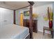Well-appointed bedroom showcasing a classic canopy bed, TV, and stylish furnishings at 3015 Yellow Lantana Ln, Kissimmee, FL 34747