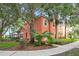 Quaint two-story home featuring vibrant tropical foliage and a screened in porch in a well landscaped setting at 3015 Yellow Lantana Ln, Kissimmee, FL 34747