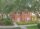 Charming home with a terra cotta roof, lush tropical landscaping, and a welcoming walkway to the front door at 3015 Yellow Lantana Ln, Kissimmee, FL 34747
