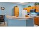 Well-equipped kitchen with plenty of cabinets, white appliances, and a breakfast bar overlooking the dining area at 3015 Yellow Lantana Ln, Kissimmee, FL 34747