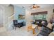 Inviting living room with a staircase, cozy seating, and a large window providing ample natural light at 3015 Yellow Lantana Ln, Kissimmee, FL 34747