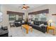 Comfortable living room with tile flooring, ceiling fan, and plenty of natural light from the many windows at 3015 Yellow Lantana Ln, Kissimmee, FL 34747