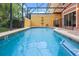 Refreshing pool area with an enclosed patio, ideal for leisurely swims and outdoor enjoyment at 3015 Yellow Lantana Ln, Kissimmee, FL 34747
