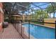 Inviting screened-in pool area with comfortable seating and lush greenery, perfect for relaxing outdoors at 3015 Yellow Lantana Ln, Kissimmee, FL 34747
