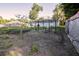 Backyard garden with greenhouse, young plants in the ground and wire structure at 3661 Se 131St Pl, Belleview, FL 34420