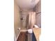 Cozy bathroom with tiled shower, decorative rug, toilet, and granite countertop at 3661 Se 131St Pl, Belleview, FL 34420